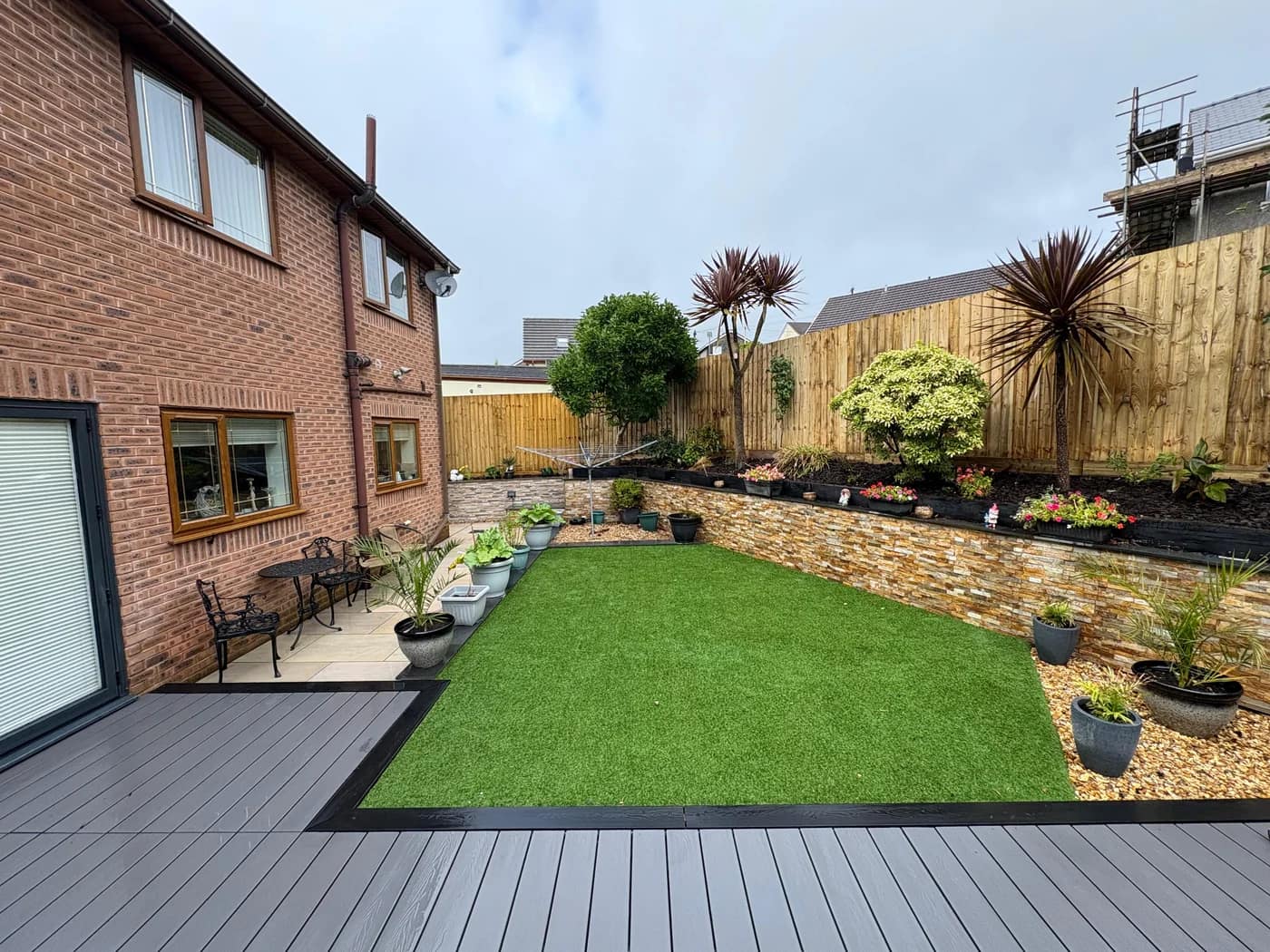 Composite decking lawn planted borders wide view bridgend by HJB