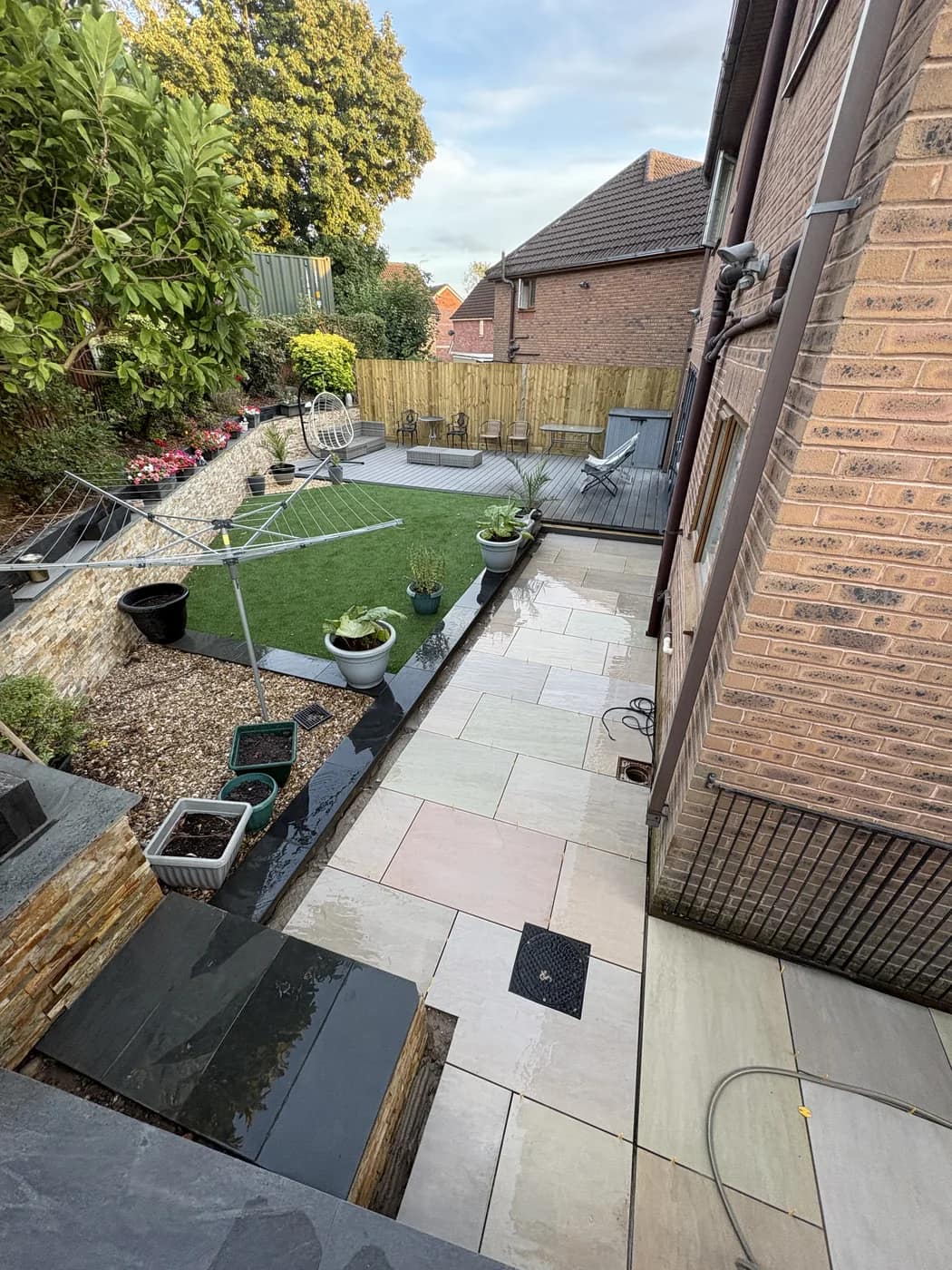 Sandstone patio artificial lawn new build garden bridgend by HJB