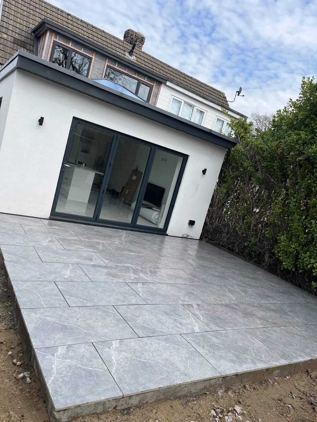 Porcelain patio beside a rear extension on a new build in Pencoed by HJB