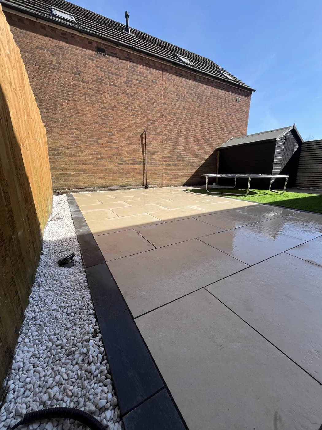 Cream porcelain patio with a gravel border in Brackla by HJB