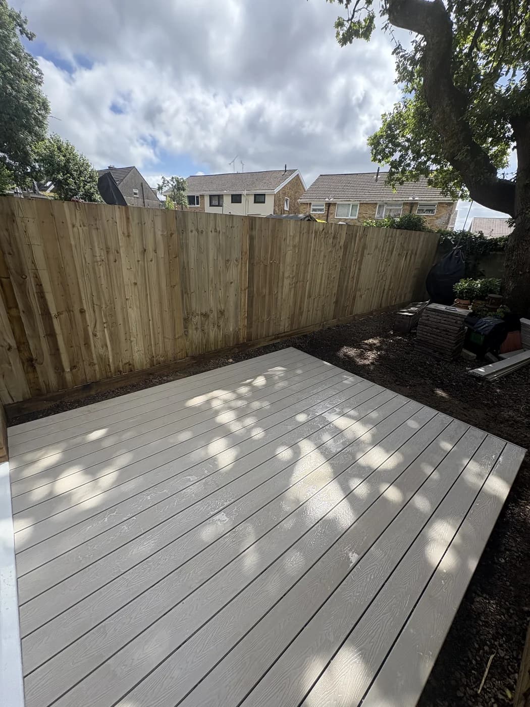 Grey composite decking and fencing in a garden in Cowbridge by HJB