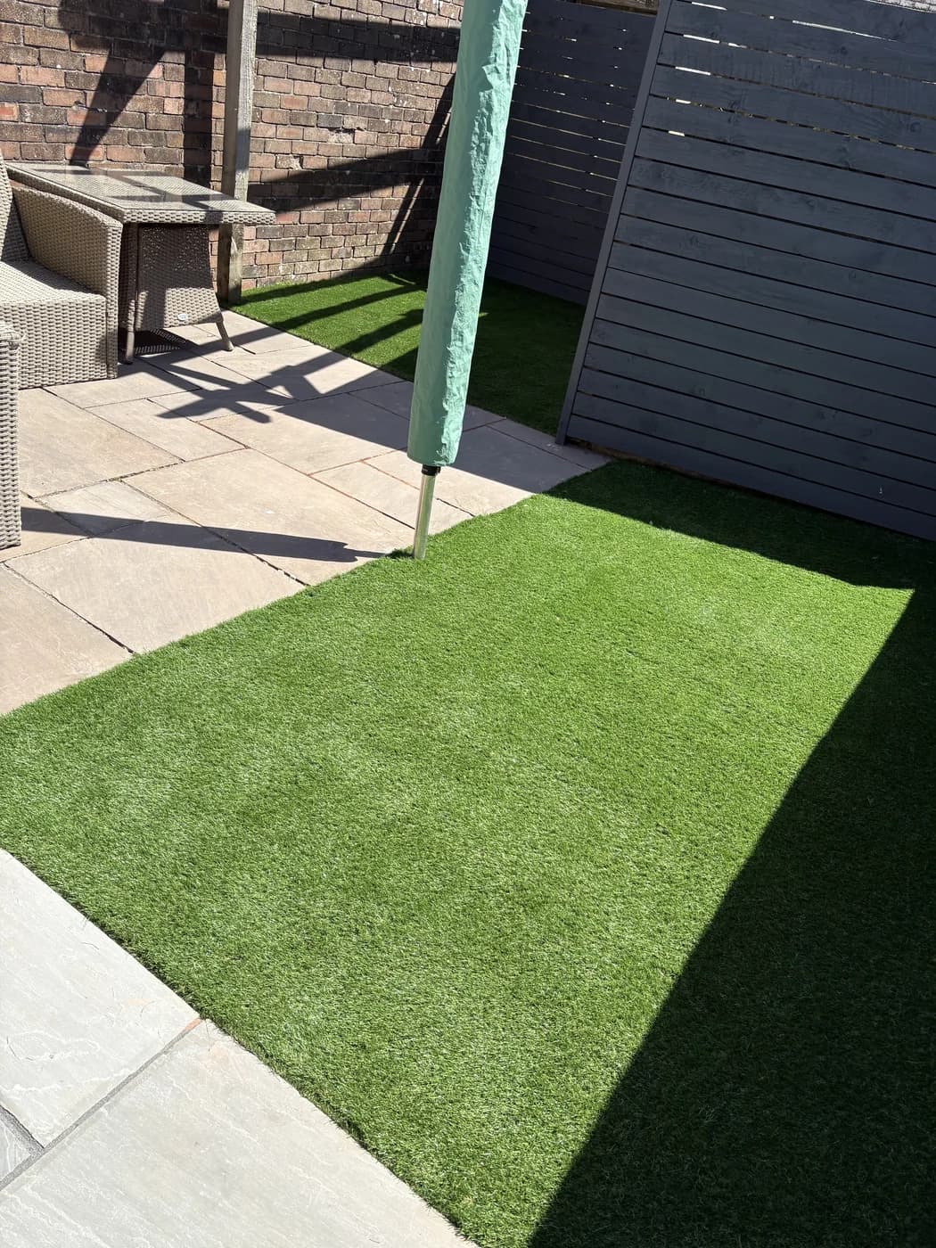 Artificial grass beside a patio in a modern garden in Bridgend by HJB